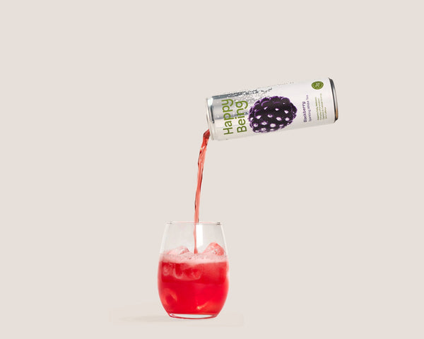 Glass of Happy Being Blueberry White Tea poured over ice for a refreshing antioxidant-rich beverage.