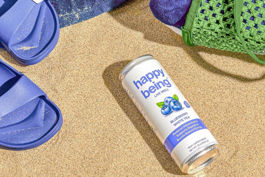 Flatlay shot of a can of Blueberry White Tea from Happy Being.