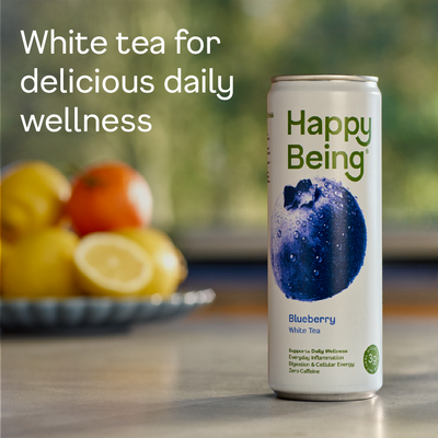 Happy Being Blueberry White Tea can with fruits in the background