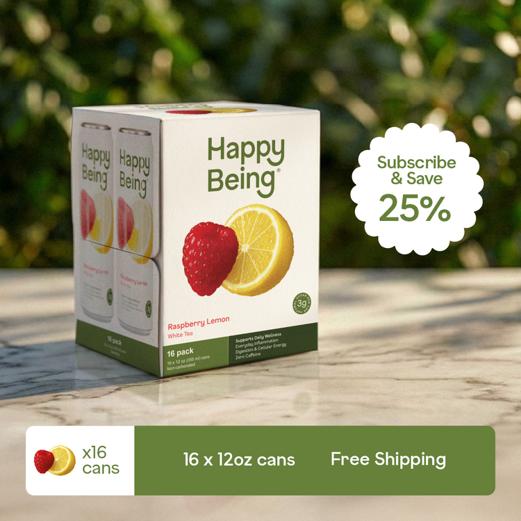 Happy Being raspberry lemon drink box with promotional text on a blurred natural background