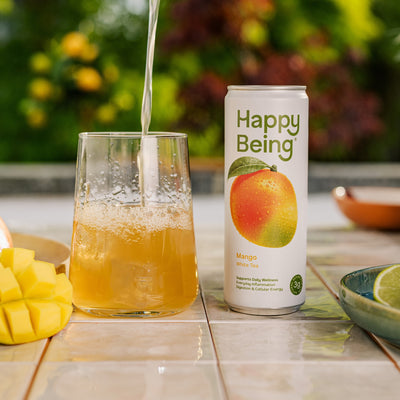 Happy Being mango drink poured into a glass.