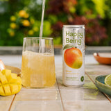 Happy Being sparkling mango drink poured into a glass.