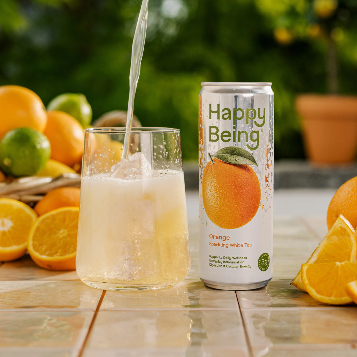 Can of Happy Being Orange Sparkling White Tea with fresh orange imagery, featuring a bright and refreshing citrus sparkling tea.