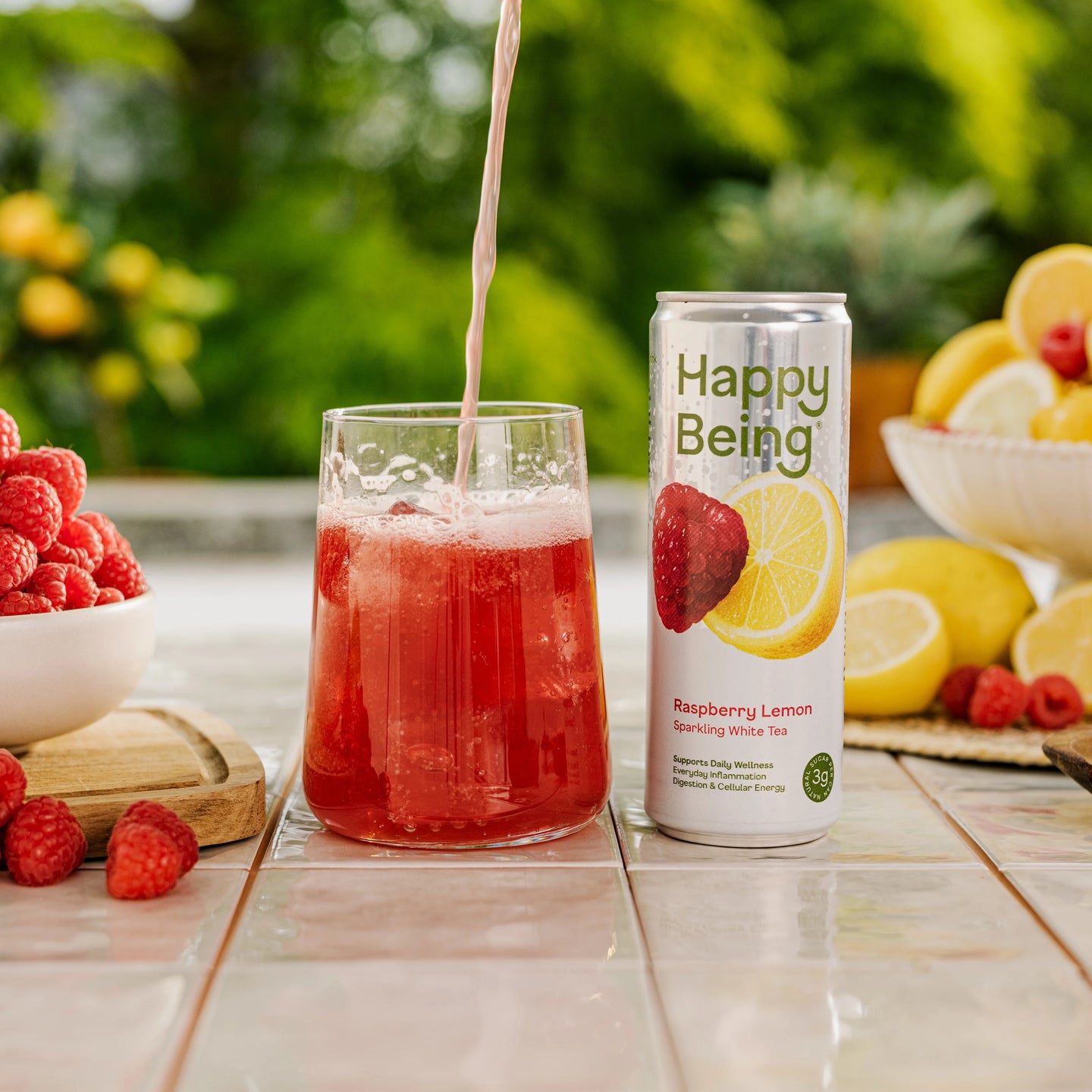 Can of Happy Being Raspberry Lemon Sparkling White Tea with raspberry and lemon artwork, featuring a bright, lightly carbonated antioxidant-rich beverage.