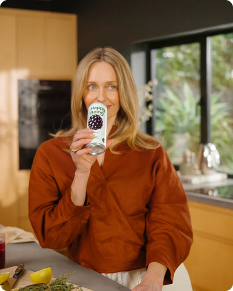 Woman enjoying Happy Being blackberry sparkling white tea